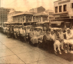 historic photograph of people on benches